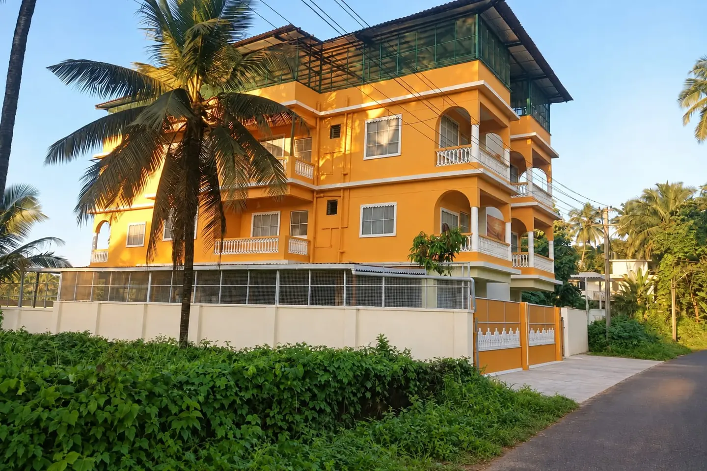 The Inteyoga centre in Sernabatim, South Goa, surrounded by palms and greenery.